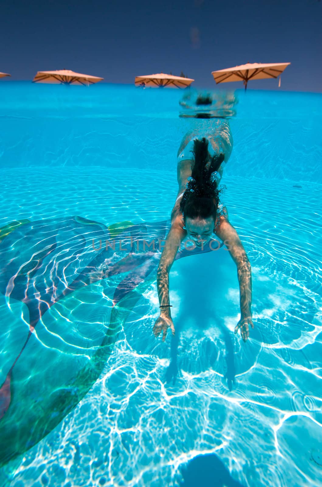 Underwater view of a woman swimming in the swimming pool