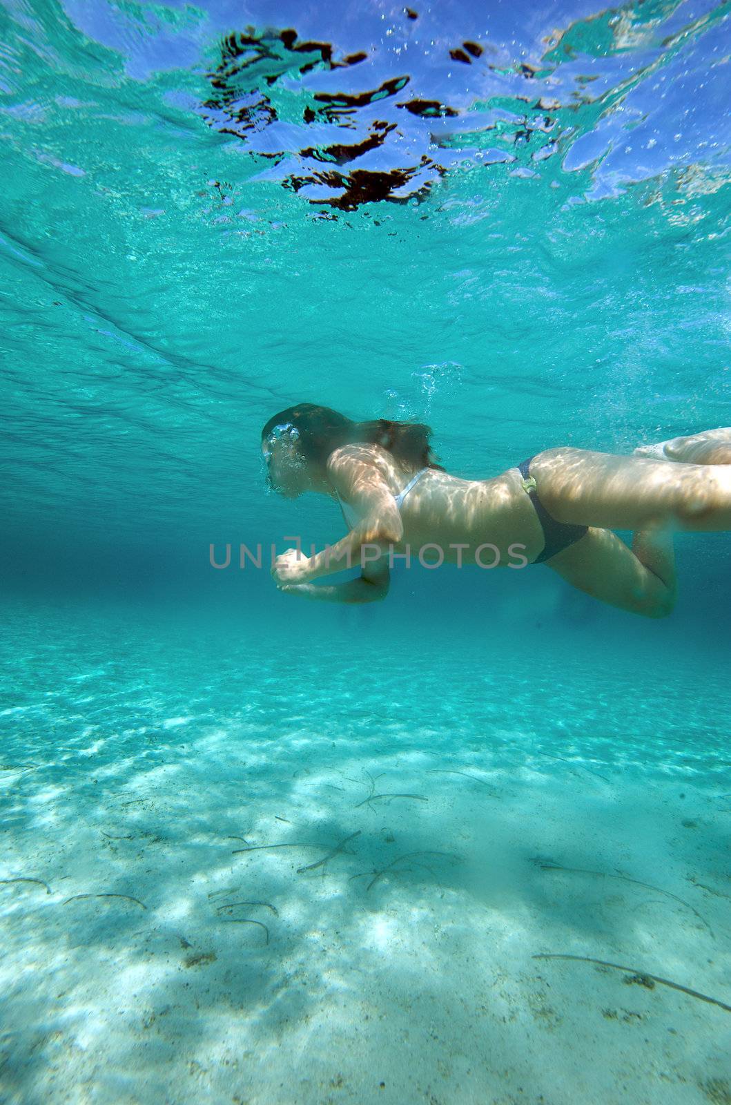 Underwater view of a woman swimming in the ocean