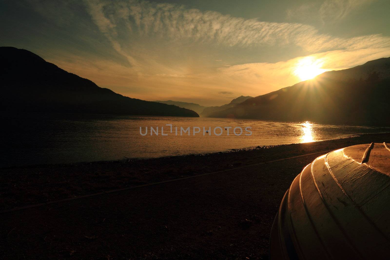 Como Lake, sunset with boat on the shore