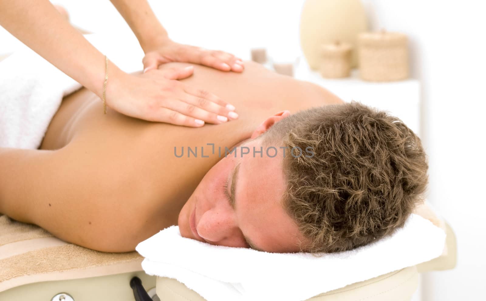 young man in a spa getting a massage