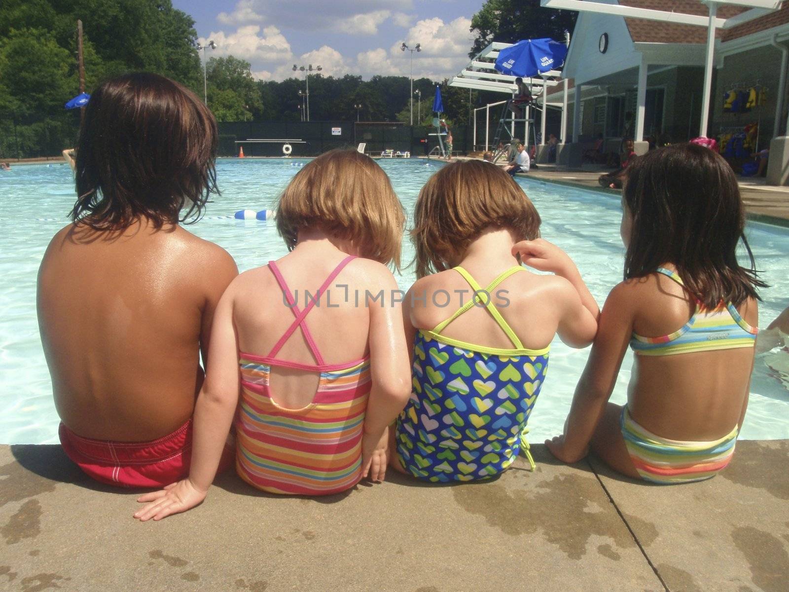 Little kids playing at neighborhood pool