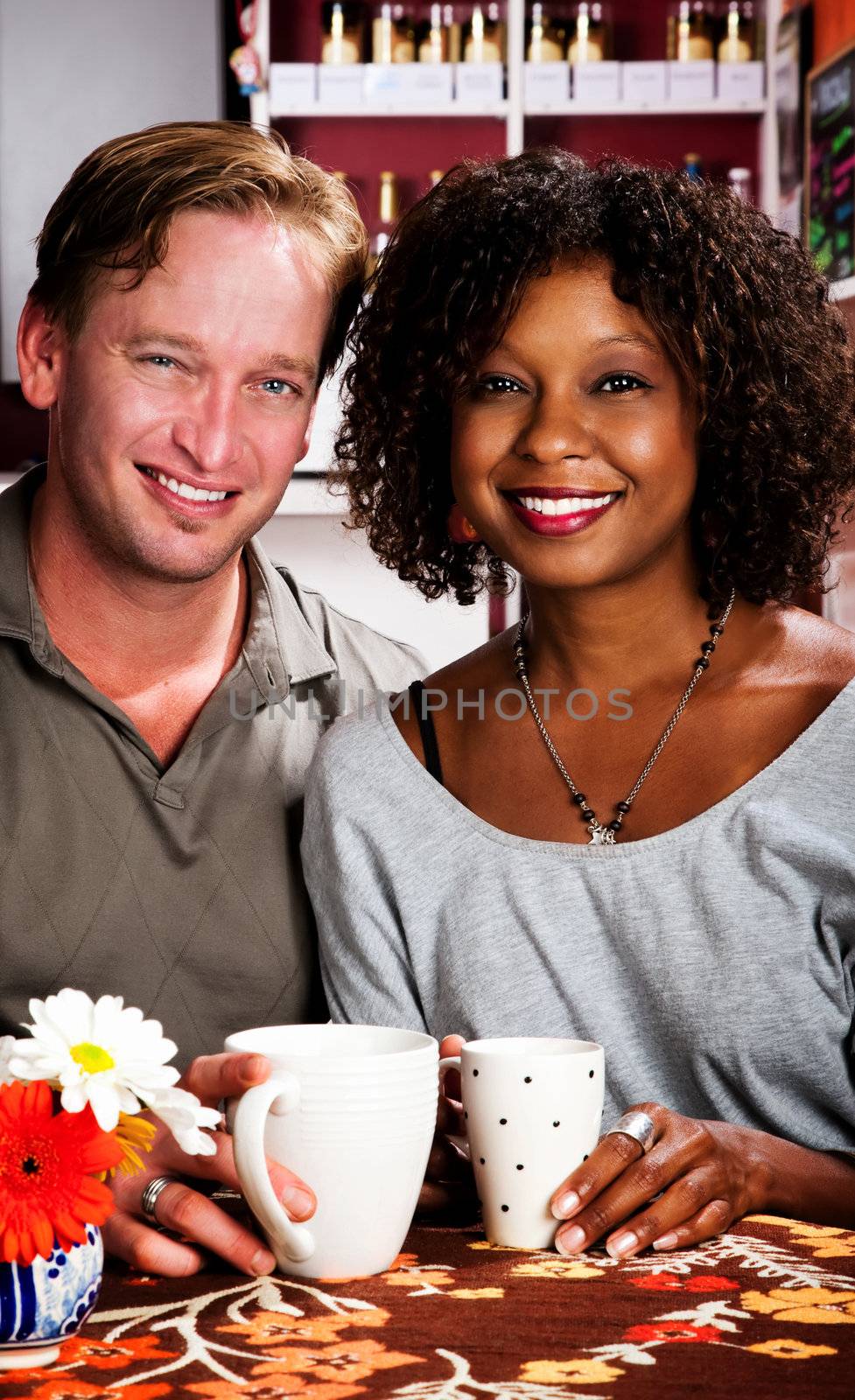 Caucasian man and African American woman in coffee house