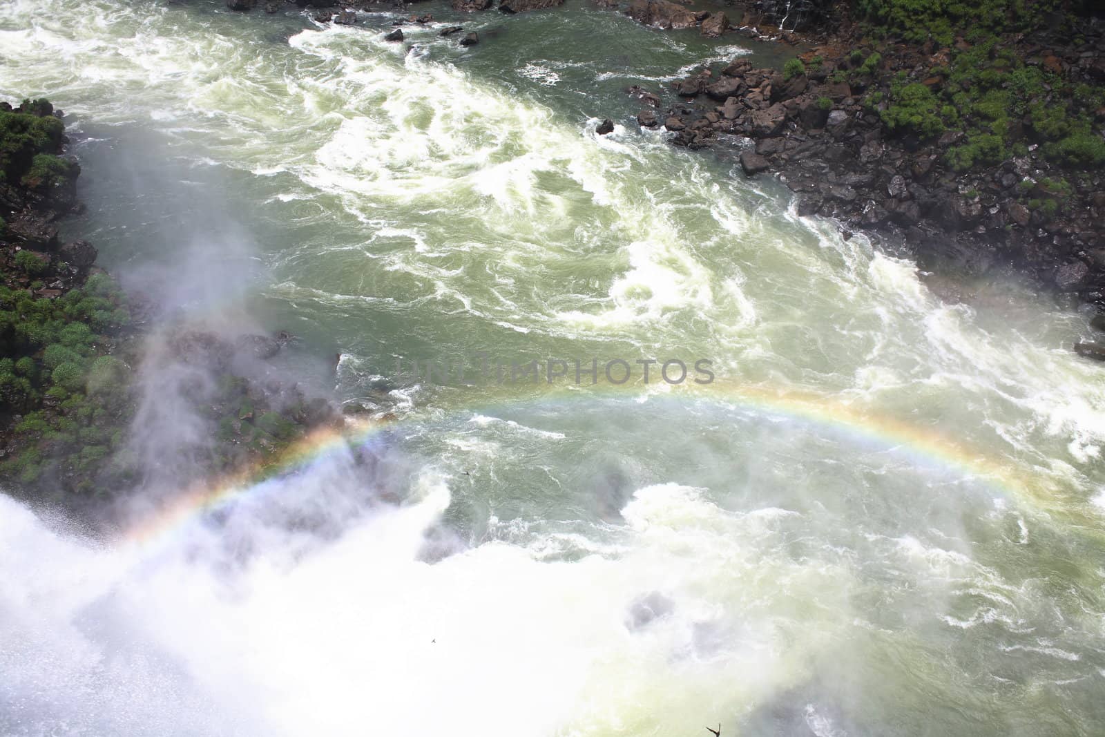 The Iguassu (or Iguazu) Falls is one of the largest masses of fresh water on the planet and divides, in South America, Brazil, Paraguay and Argentina. The waterfall system consists of 275 falls along 2.7 kilometres (1.67 miles) of the Iguazu River. Some of the individual falls are up to 82 metres (269 feet) in height, though the majority are about 64 metres (210 feet).