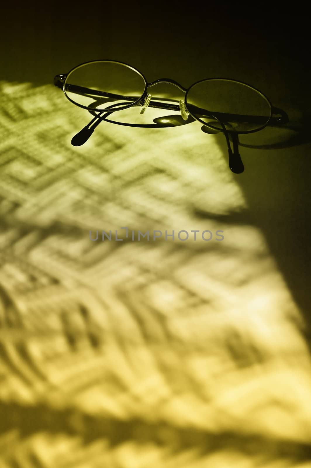 Eyglasses in dramatic shadows