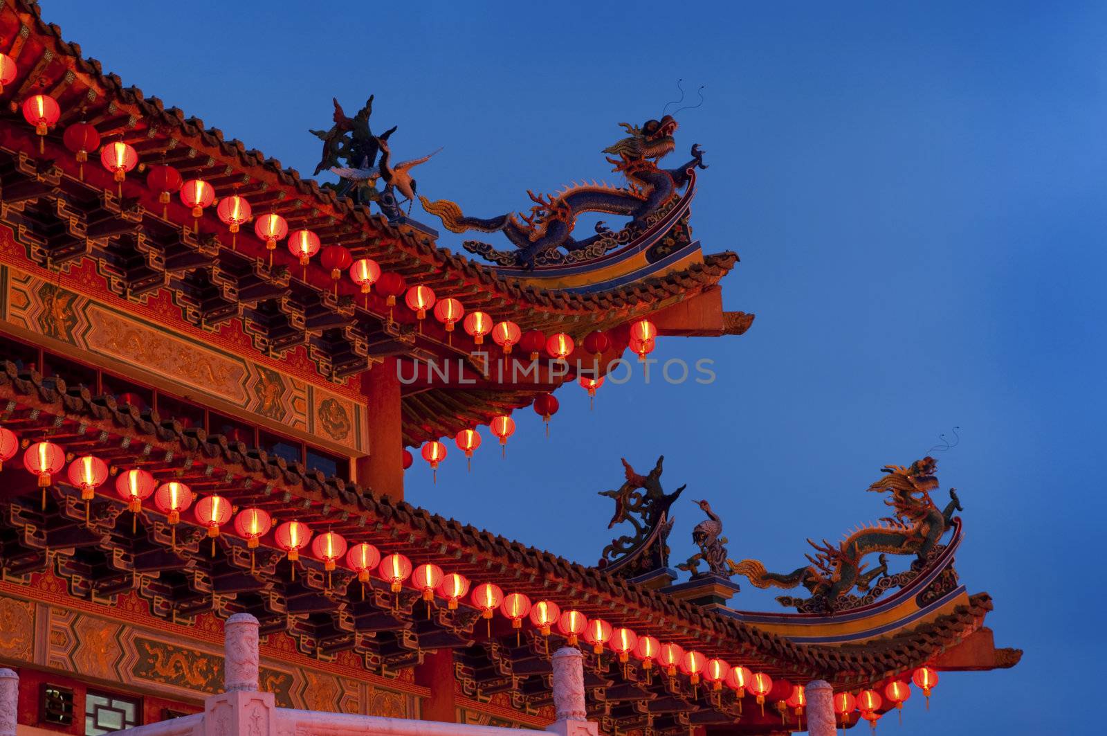 Buddhist Temple with red lantern at dusk.