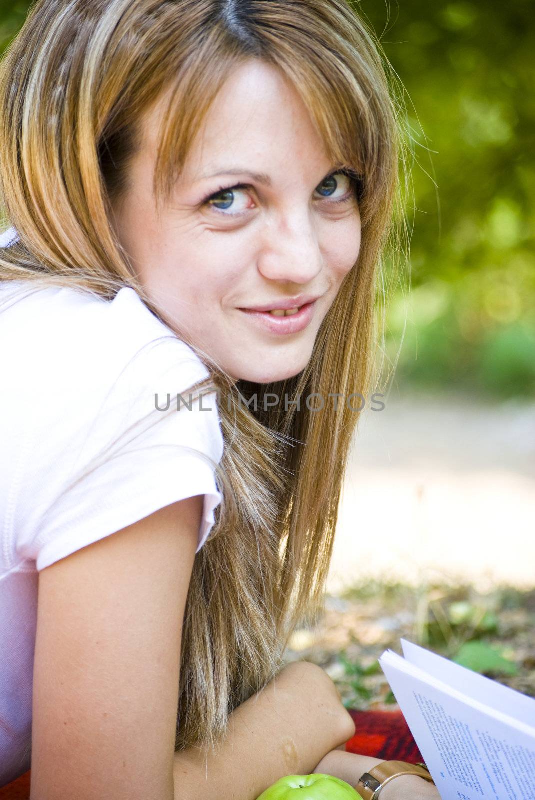 beautiful young woman reading book outdoor