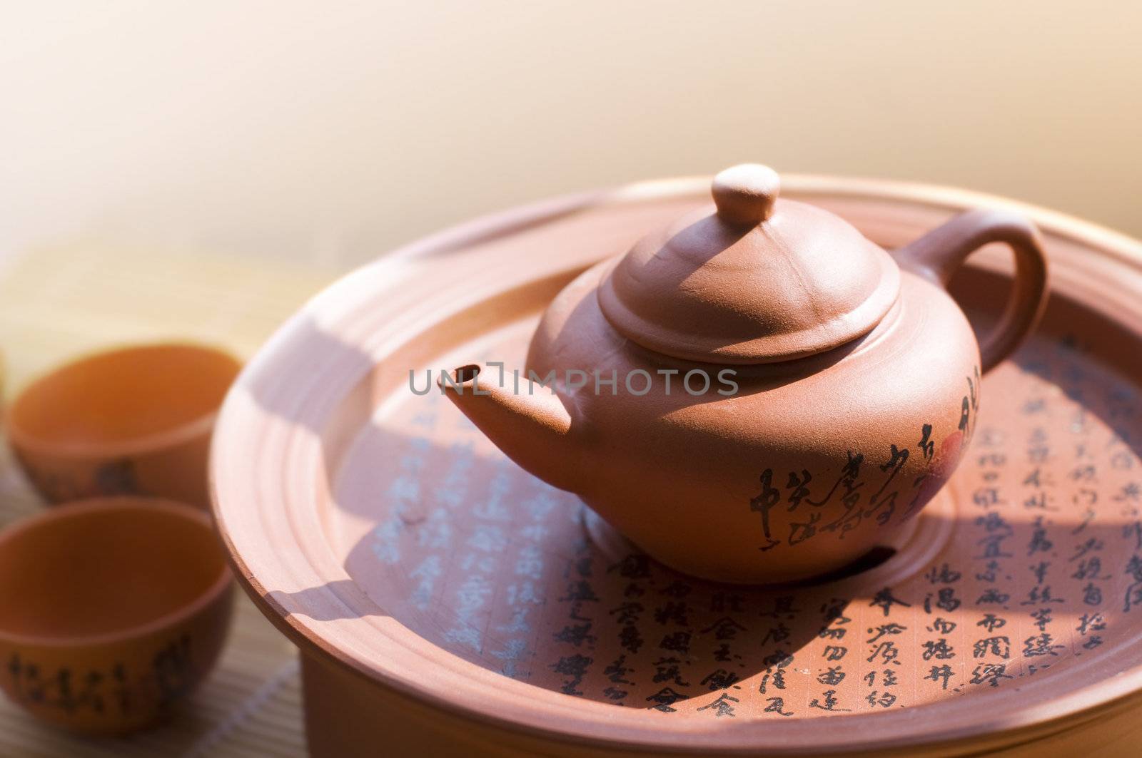 Chinese ceramic teapot and cups. The Chinese word on the pot is a poem.