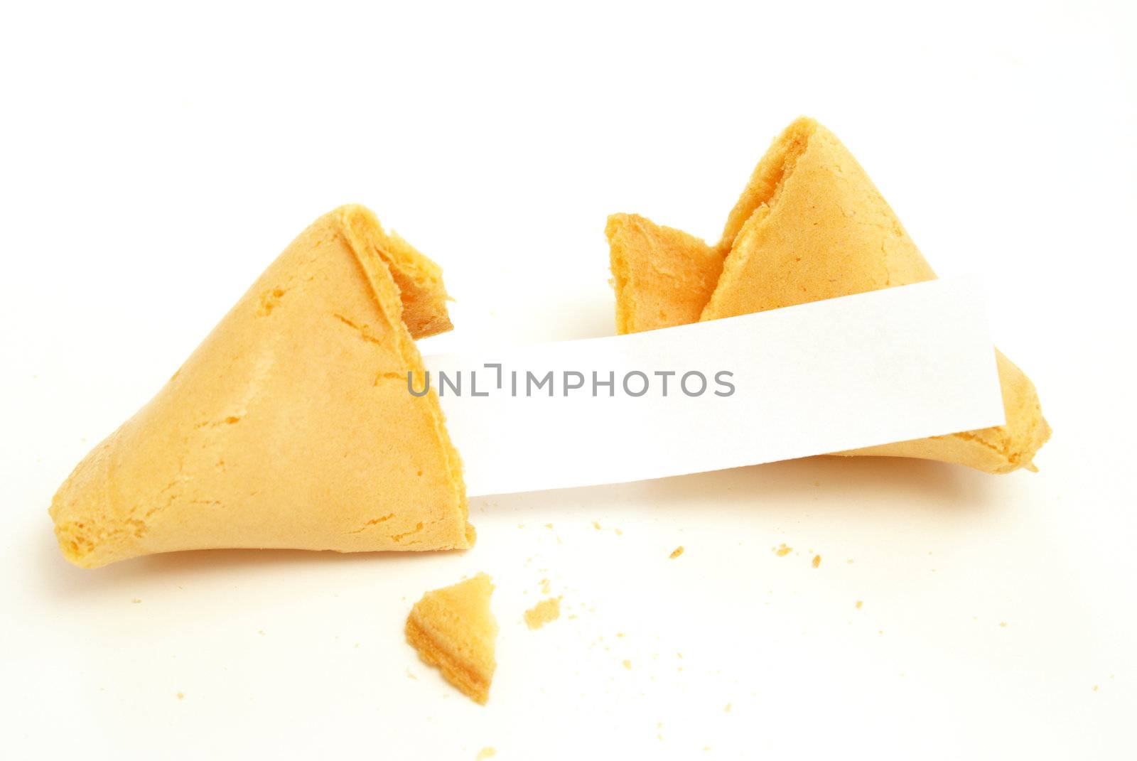 A fortune cookie on white background with a blank paper for your message.