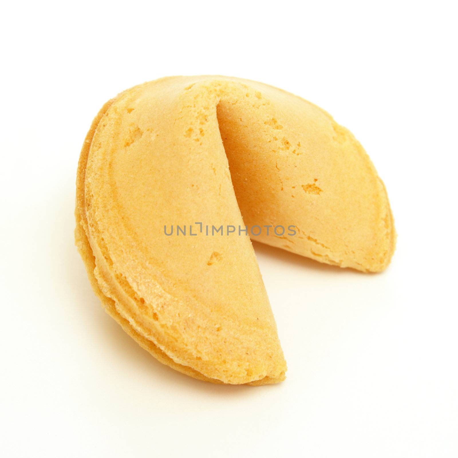 A whole fortune cookie on white background.