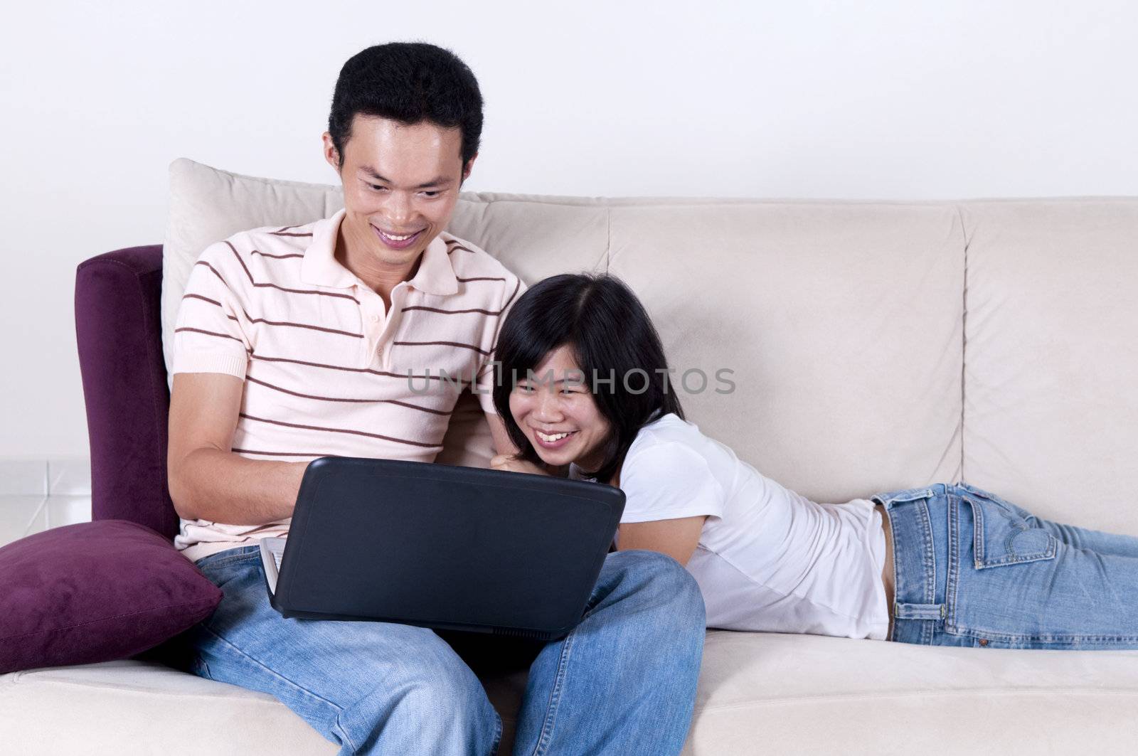 Asian young couple sharing informations from internet.