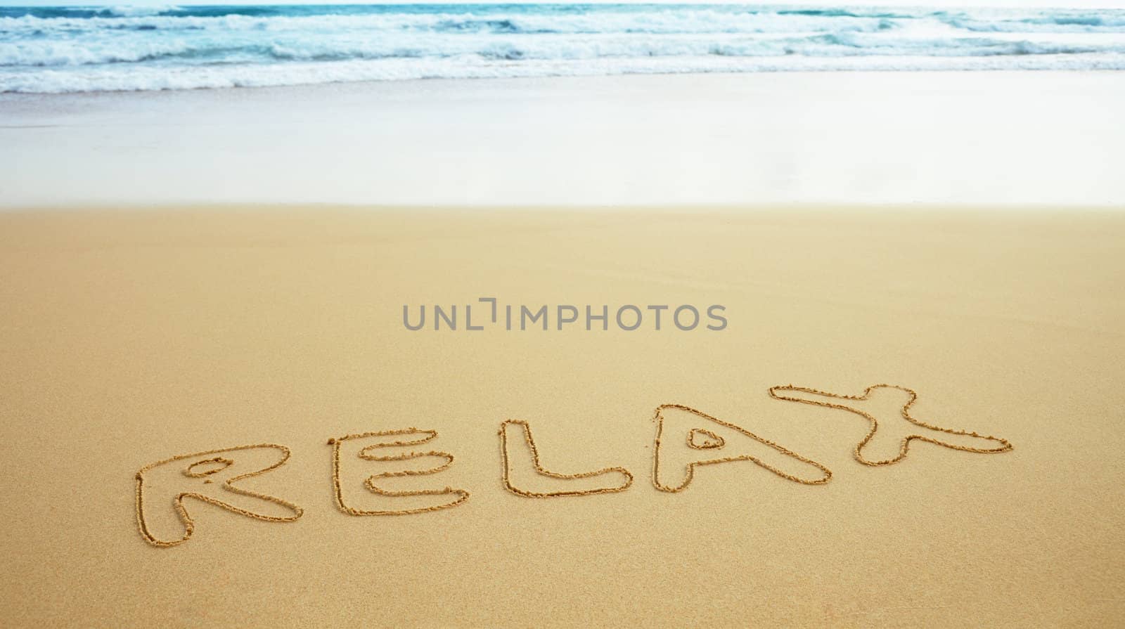 Inscription on beach sand - relax by pzaxe