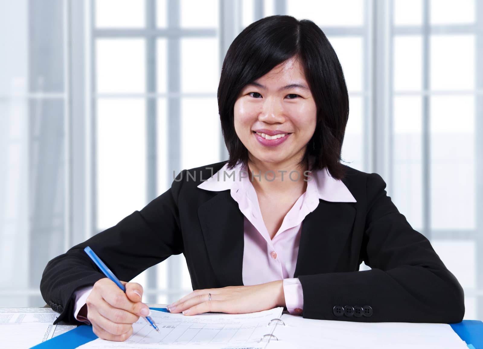 Asian woman working in office by szefei