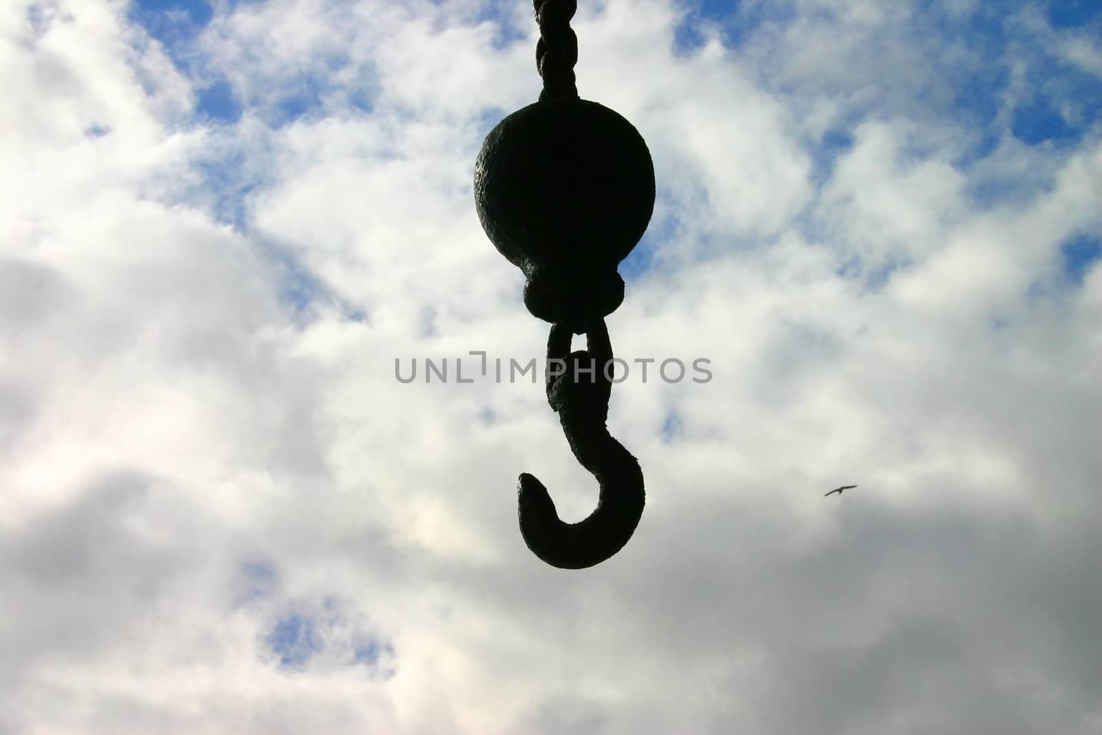 Silhouette of Crane Hook Against Cloudy Sky