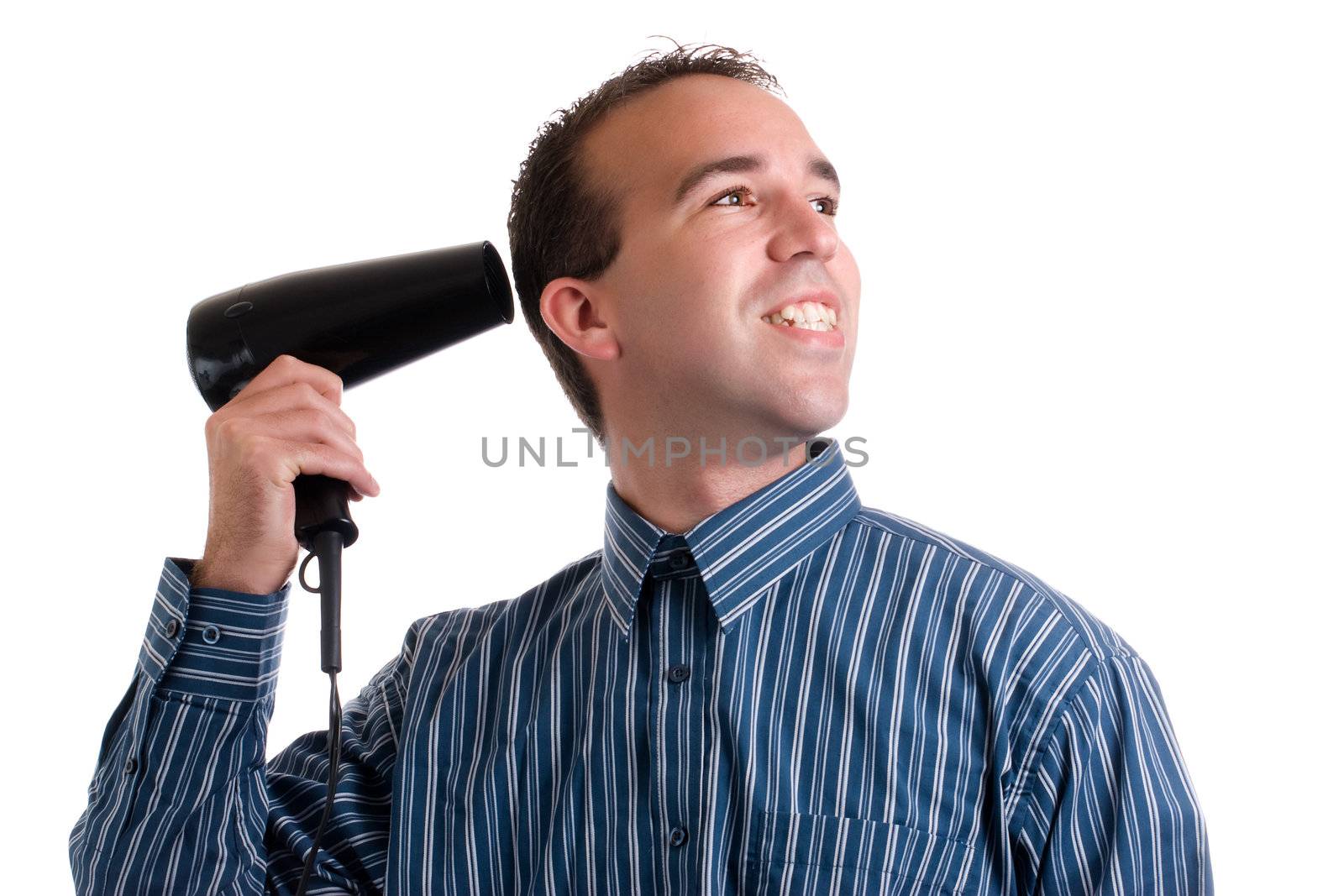 A young man dressed for work and blowdrying his hair, isolated against a white background