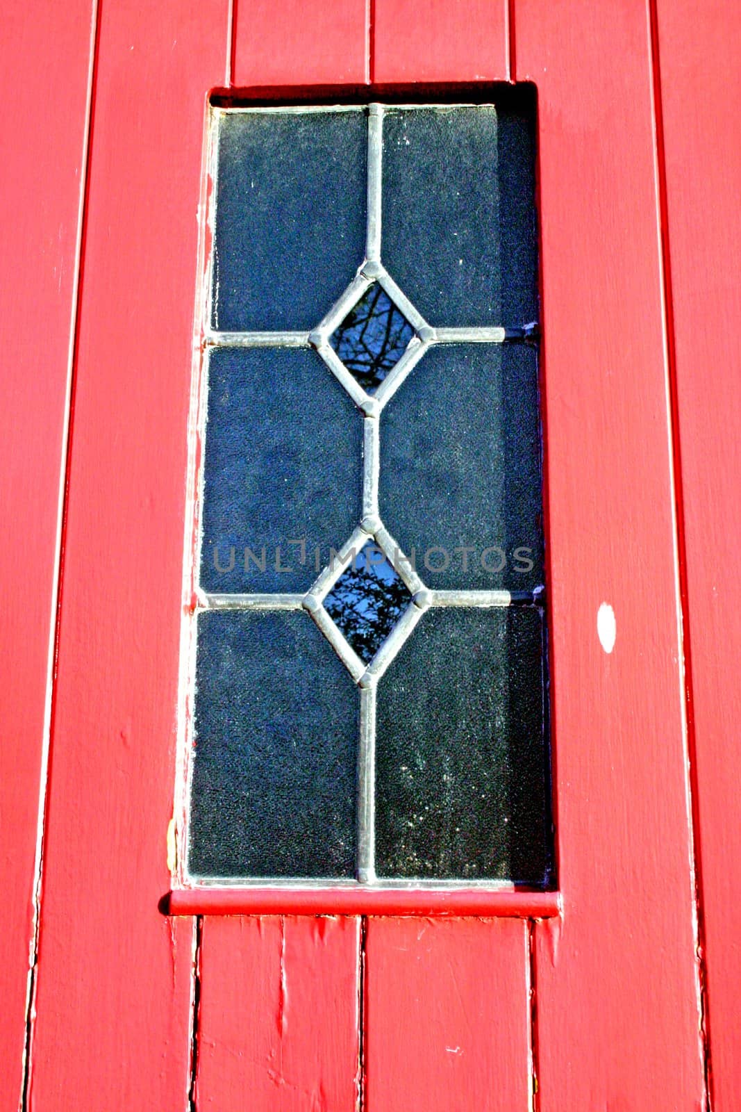 Closeup of Window in Red House Door