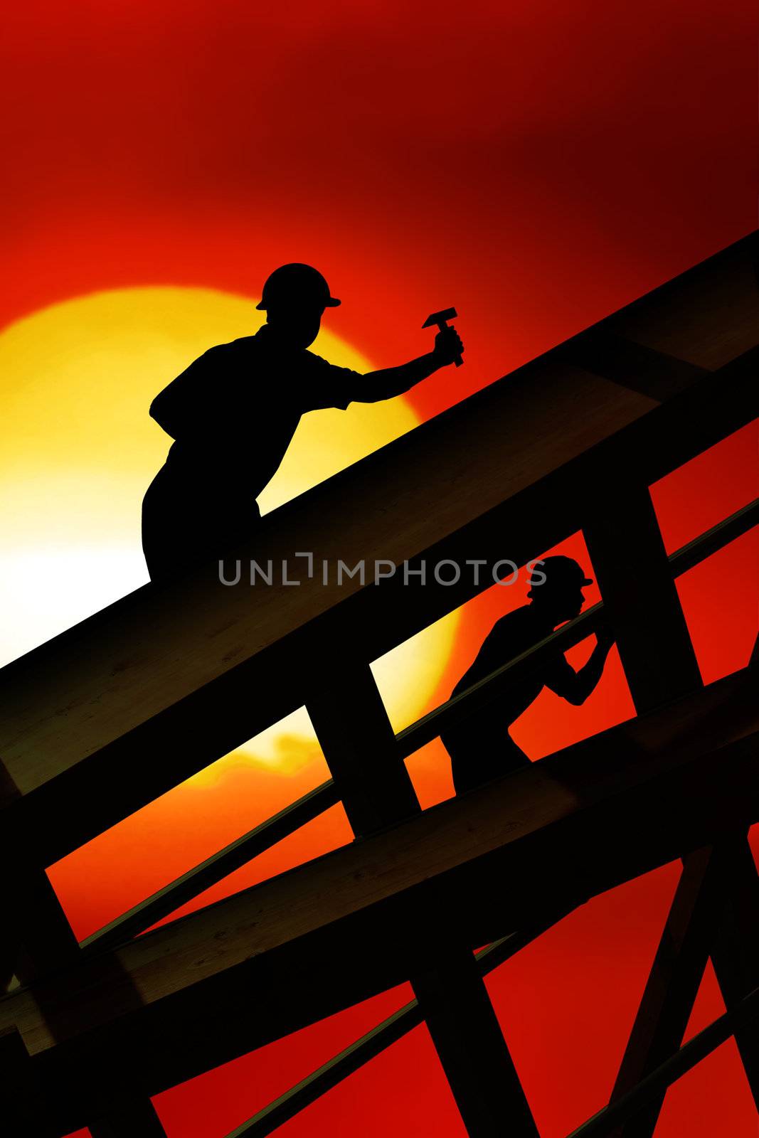 two workers on a roof top with sunset