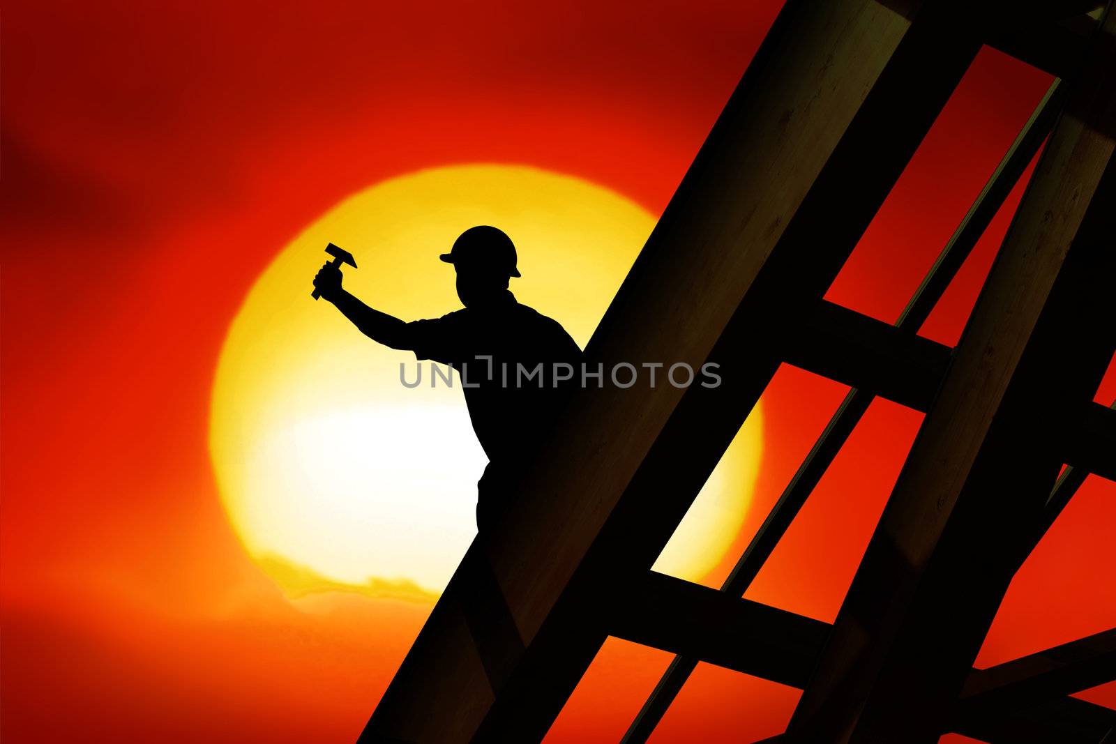 two workers on a roof top with sunset