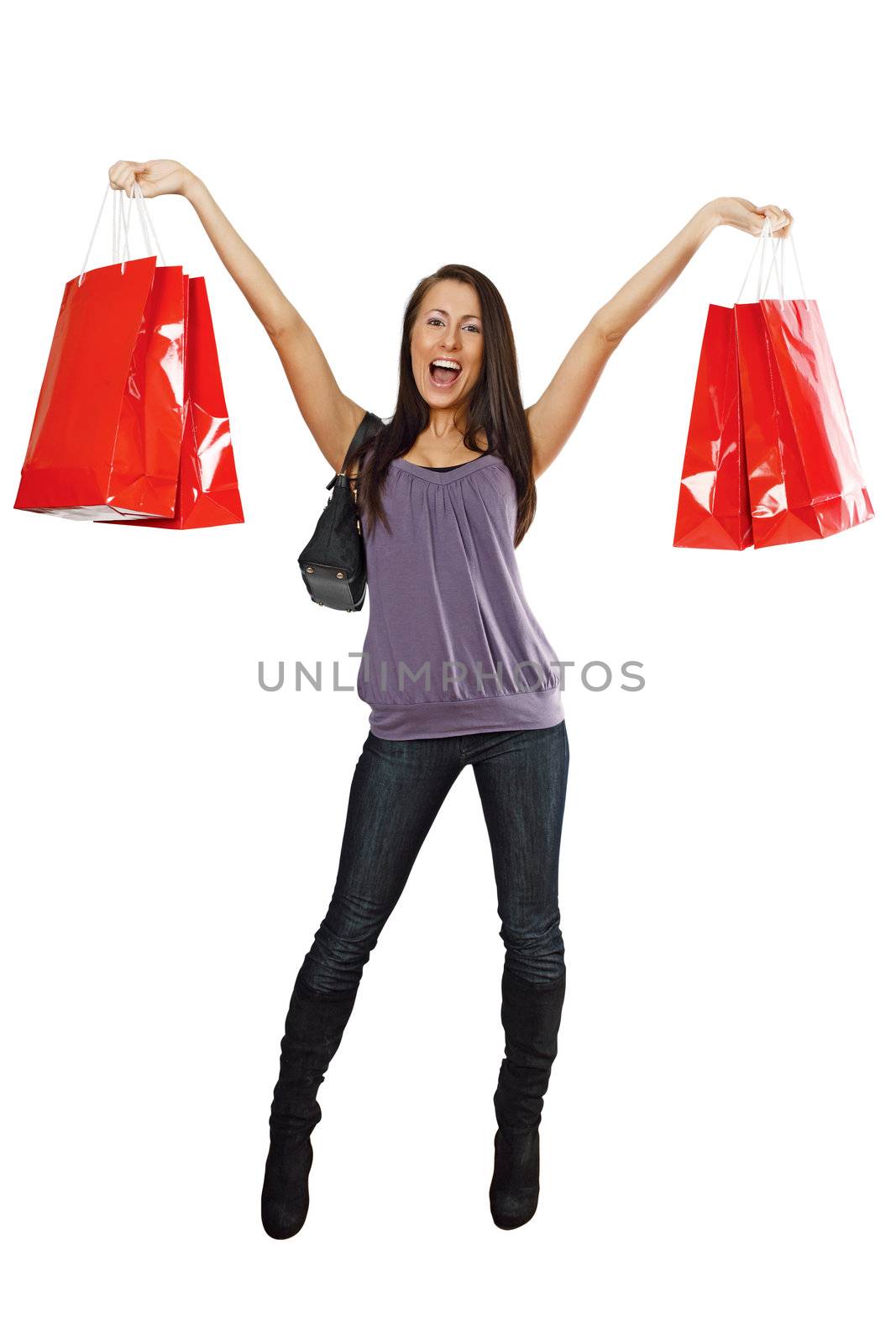 A very happy shopping girl holding bags and smiling wildly about her rabid consumerism.
