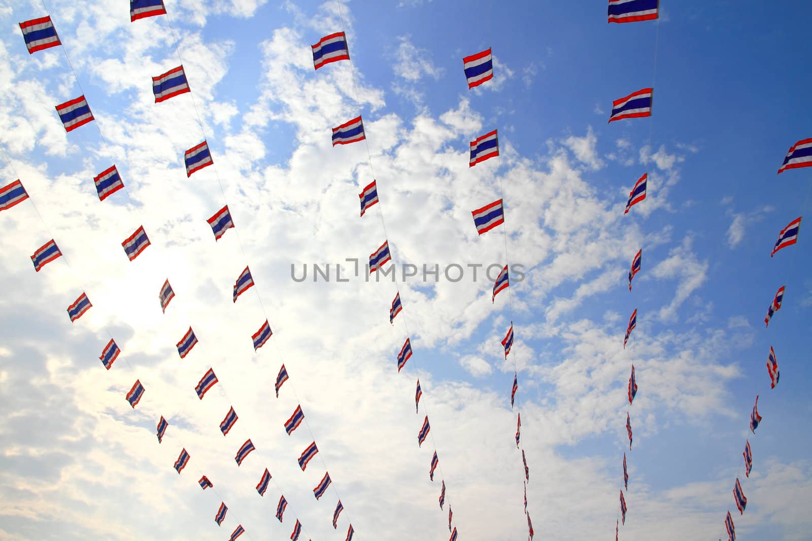 waving Thai flags hanging on a blue sky