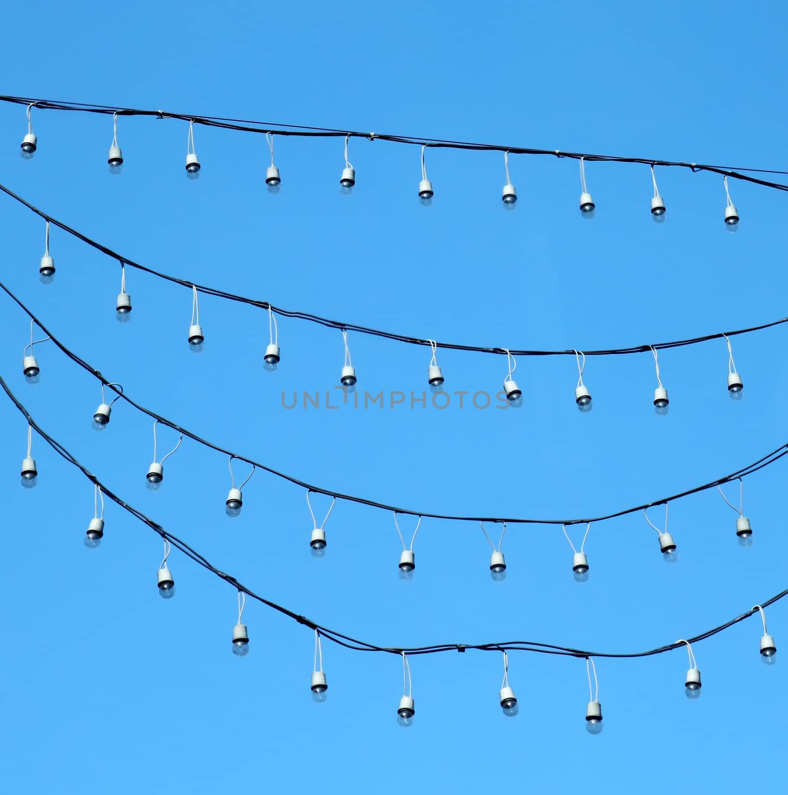 hanging holiday light over blue sky