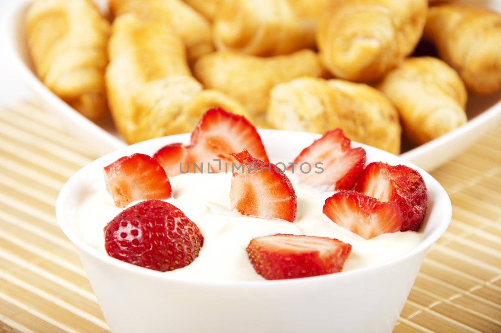 light Breakfast: croissants and Berries on a table on a light background