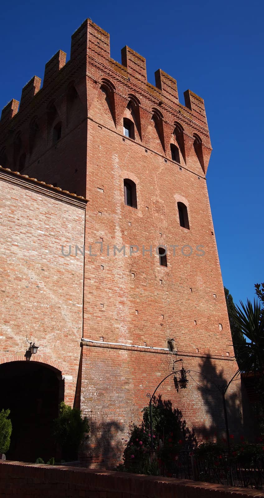 Castle from red bricks in Tuscany near Monte Oliveto Maggiore in Italy.