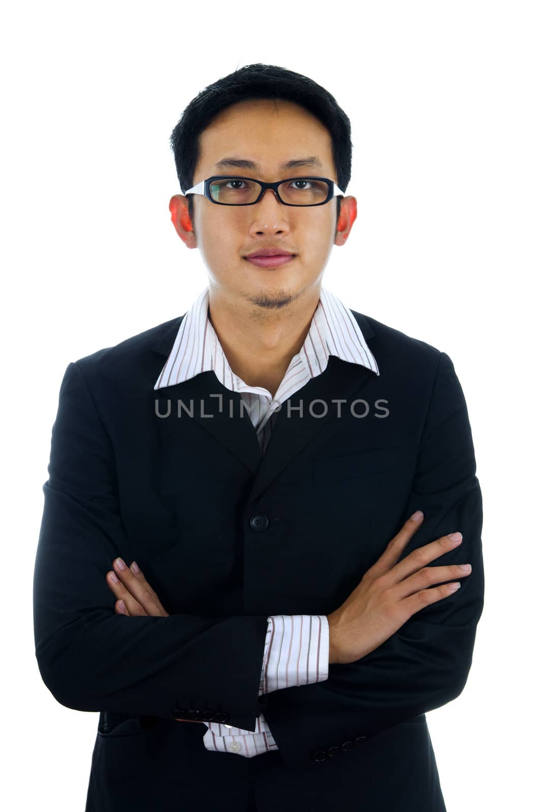 Arms crossed young Asian executive.
