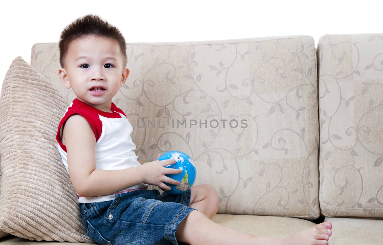 Portrait of Asian little boy with globe toy.