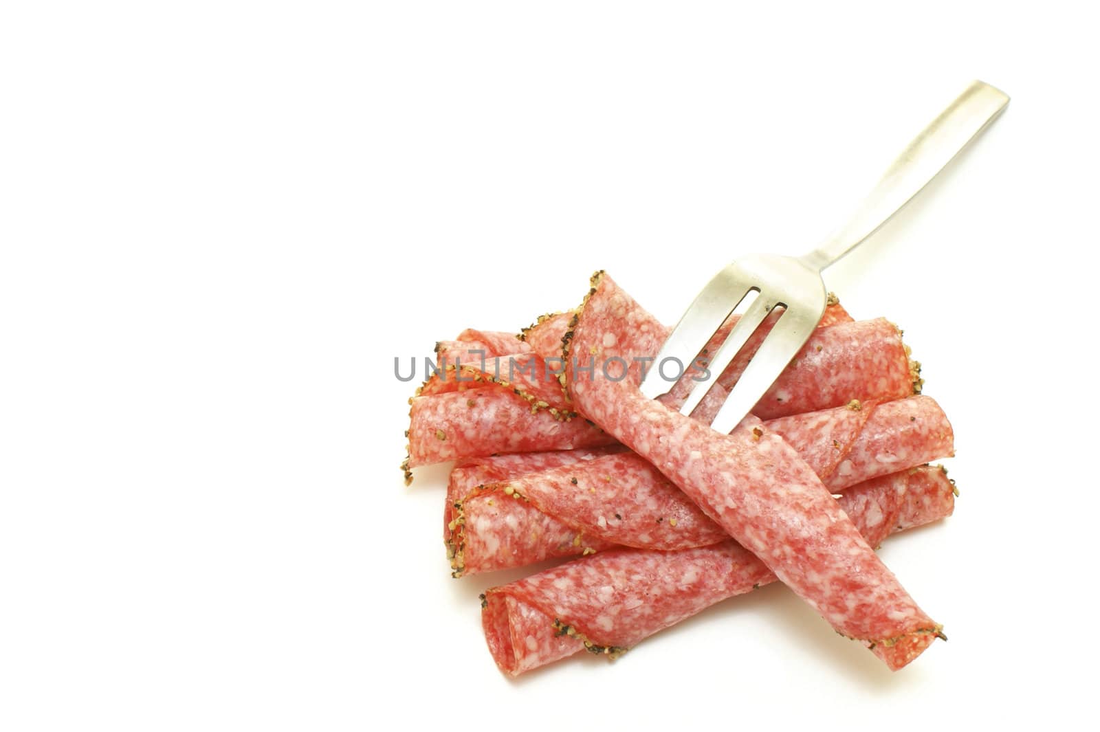 some salami slices and a fork