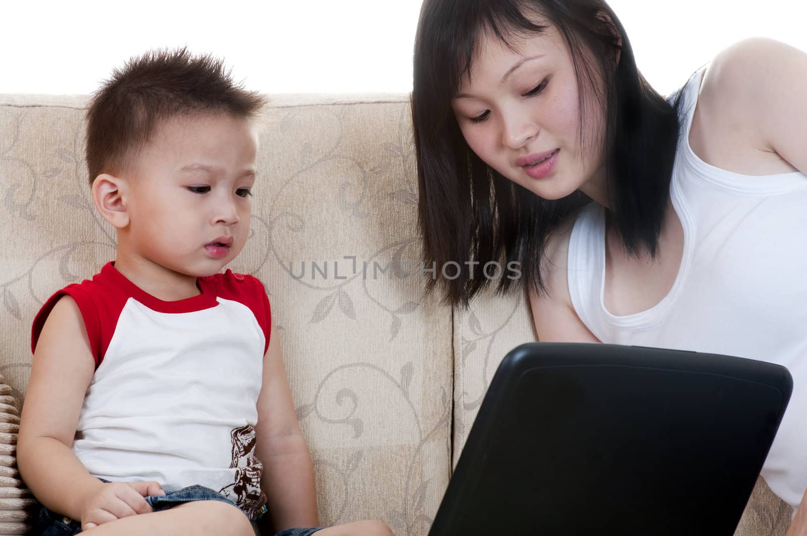 Young mother with her son using a laptop
