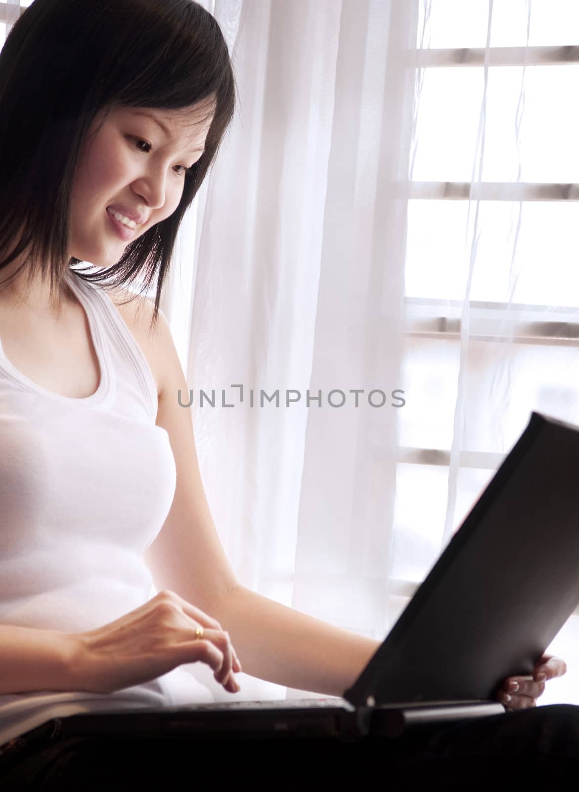 Happy Asian women using internet.