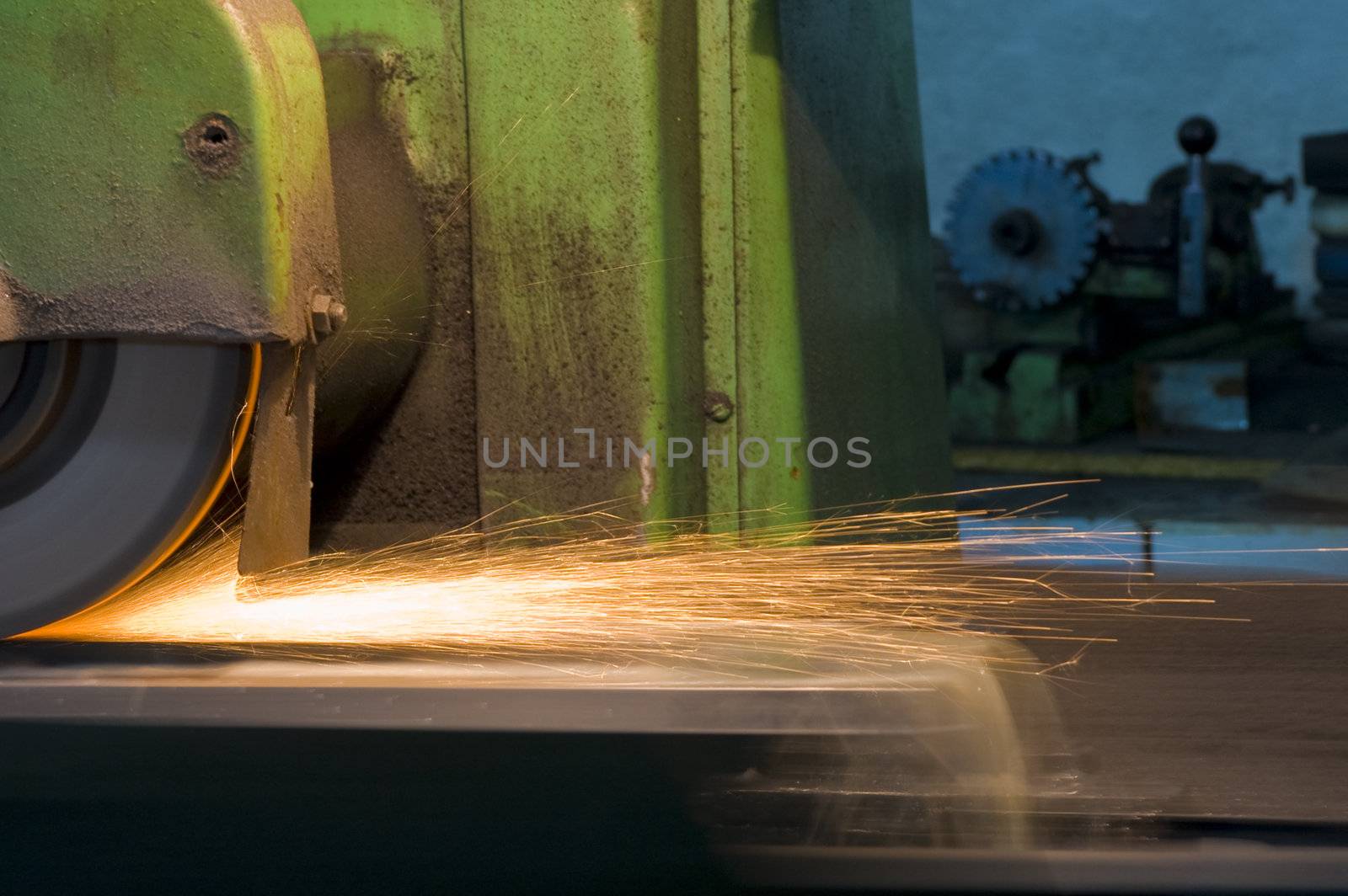 bright sparks of a spinning grinder at a factory
