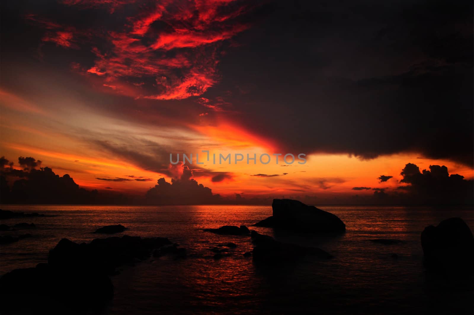 Sun rising over water horizon at Teluk Cempedak (Jackfruit Bay), a famous beach in Kuantan, Pahang, Malaysia, Asia.