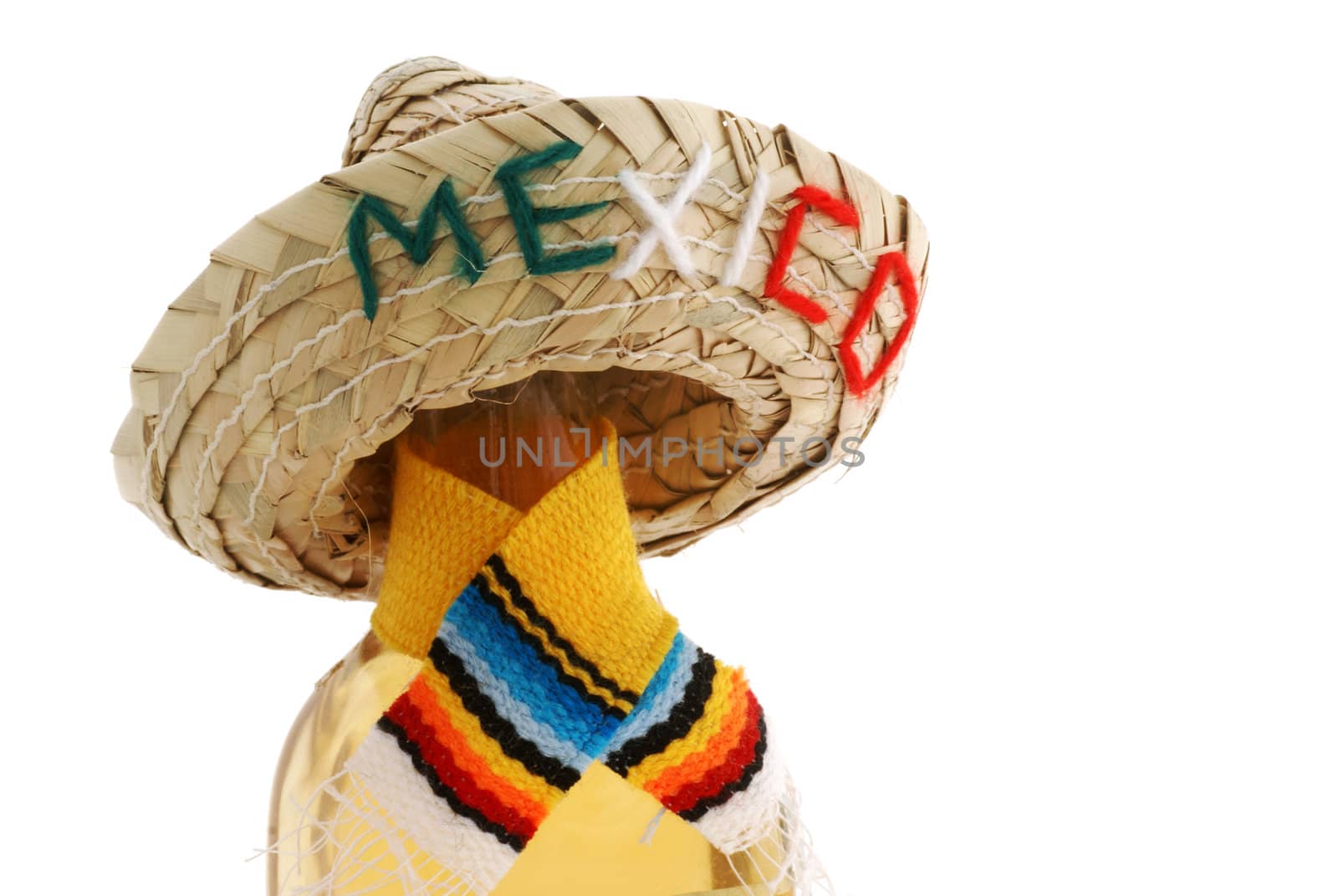 Bottle with shawl and Mexico hat, isolated on white.