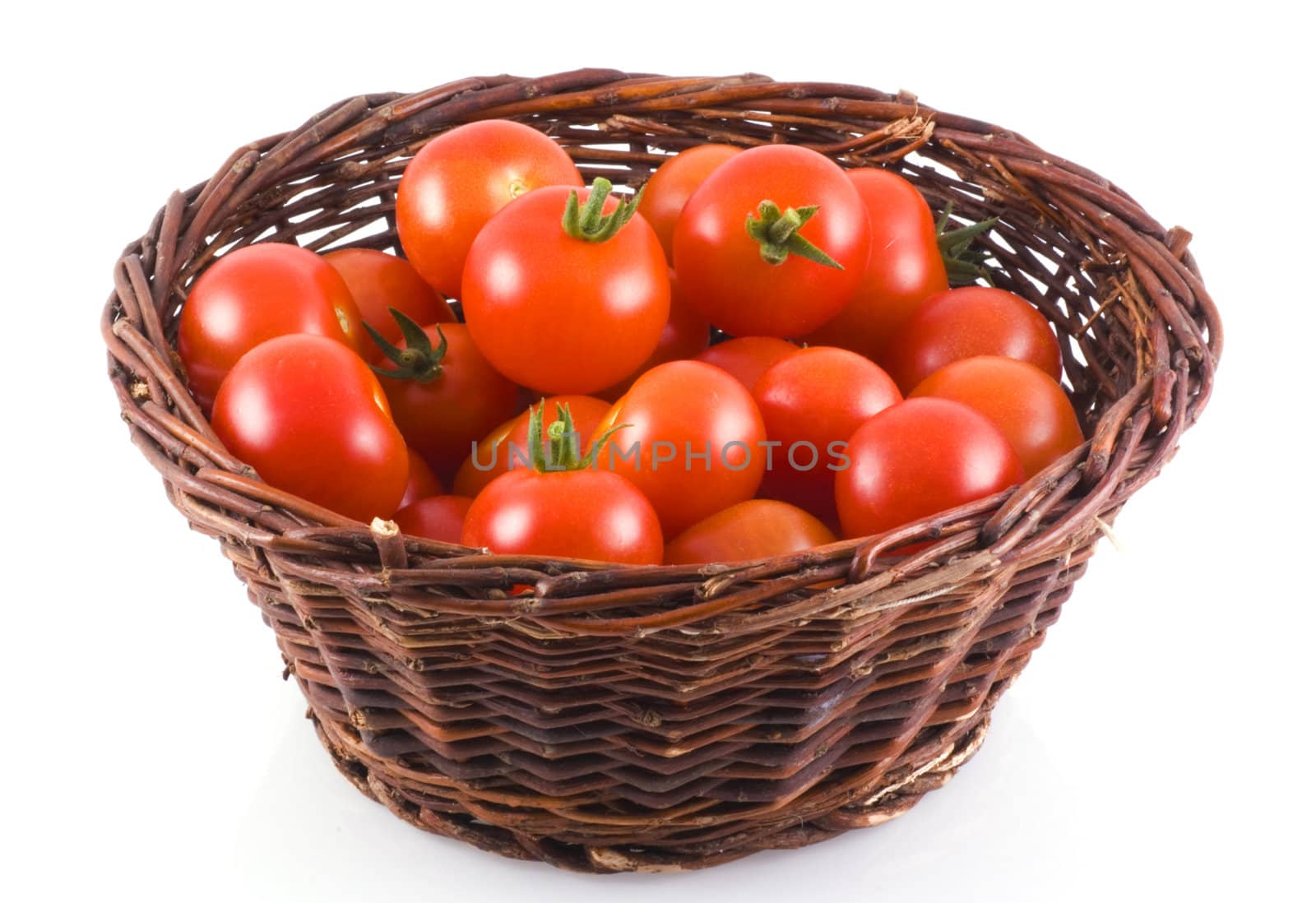 Basket full of cherry tomatoes, isolated on white.
