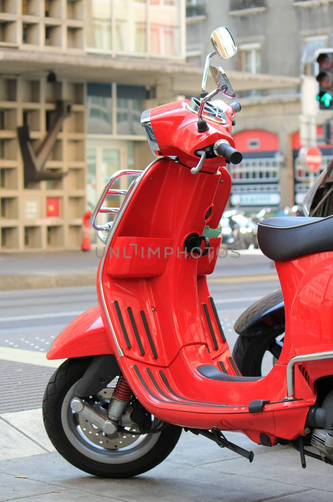 Red scooter parked in the city street