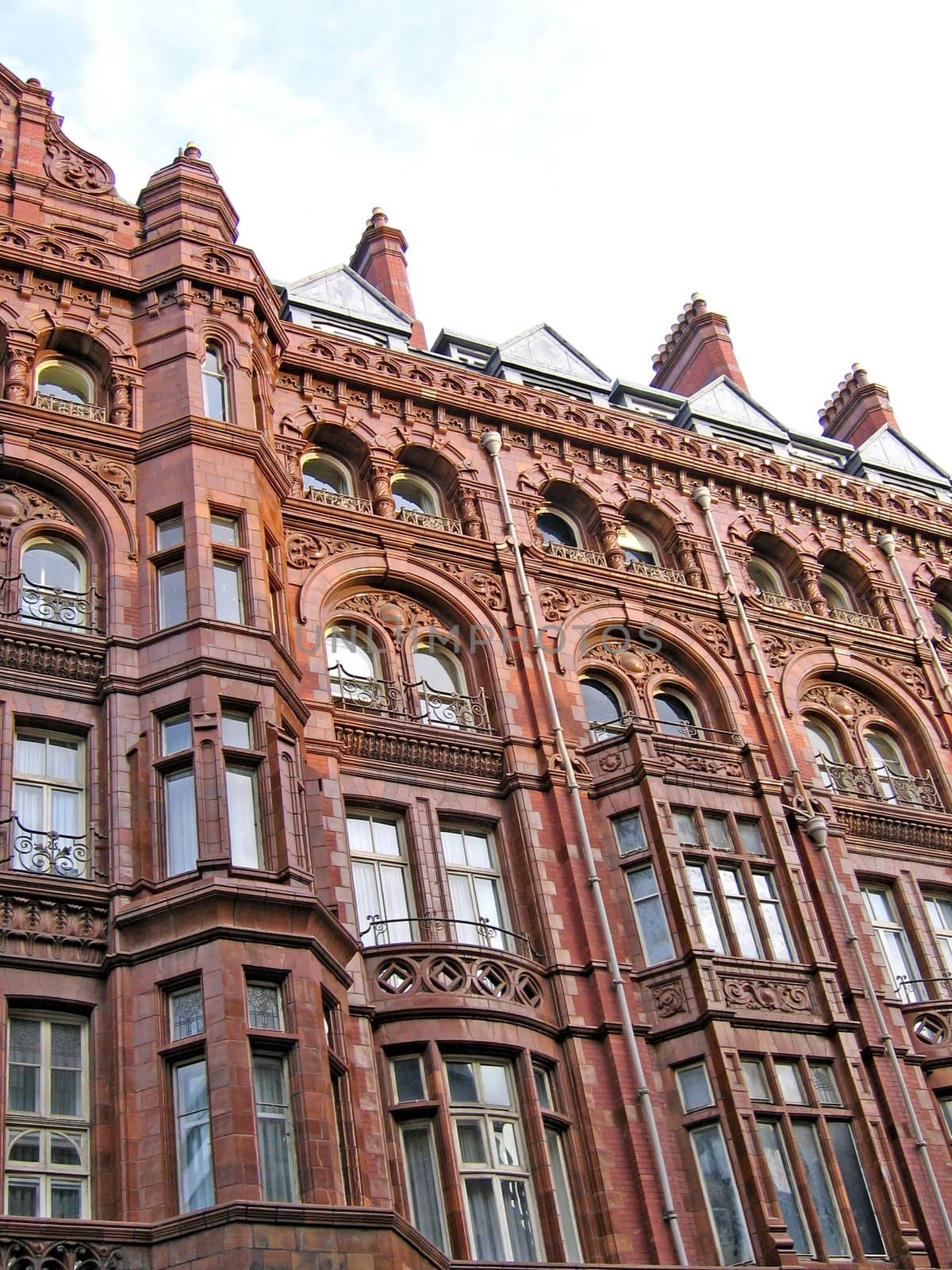 Ornate Building with Many windows and Chimneys