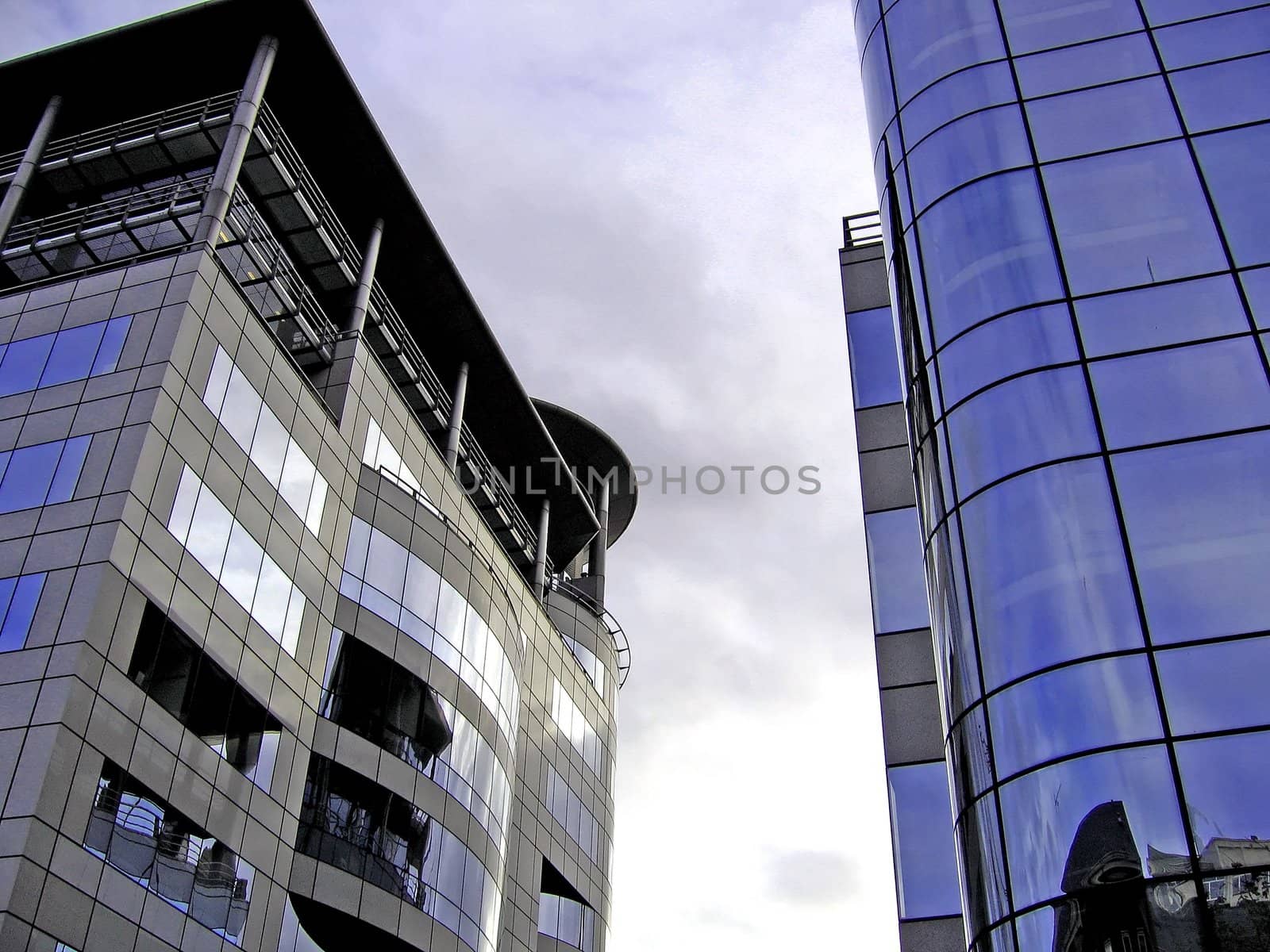 Two Reflective Modern Office Buildings on a Cloudy Day