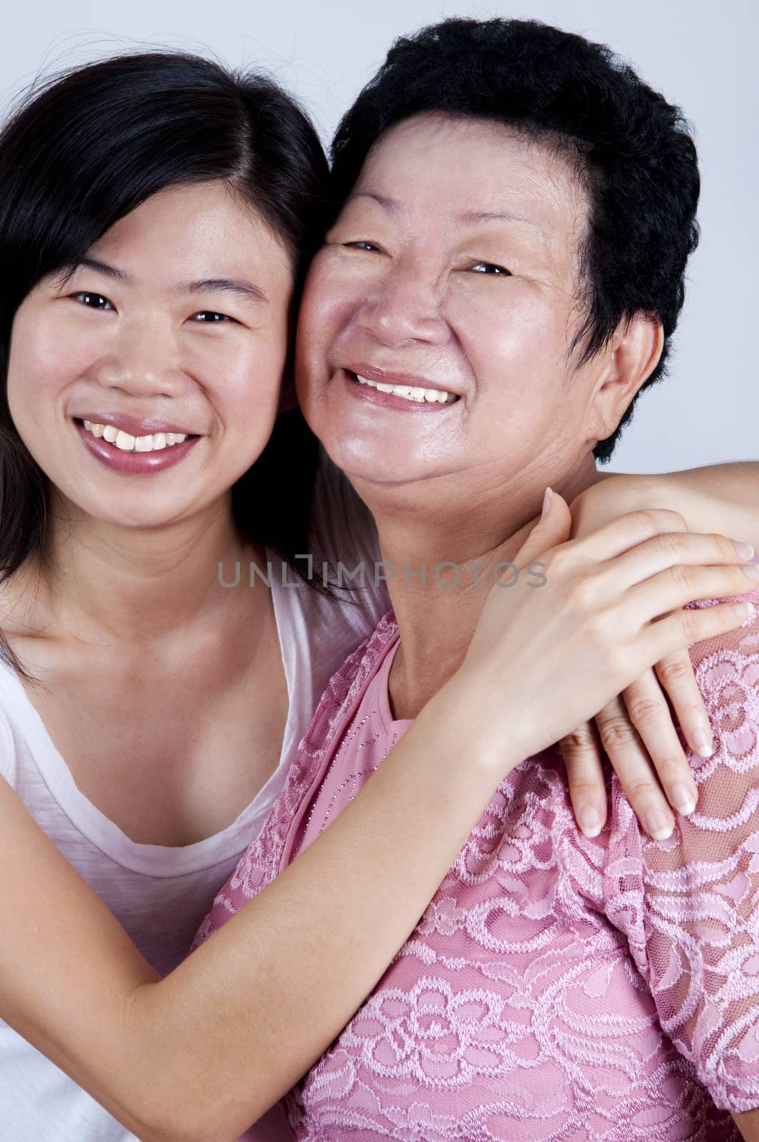 Happy Asian Family. Daughter hugging her mother.