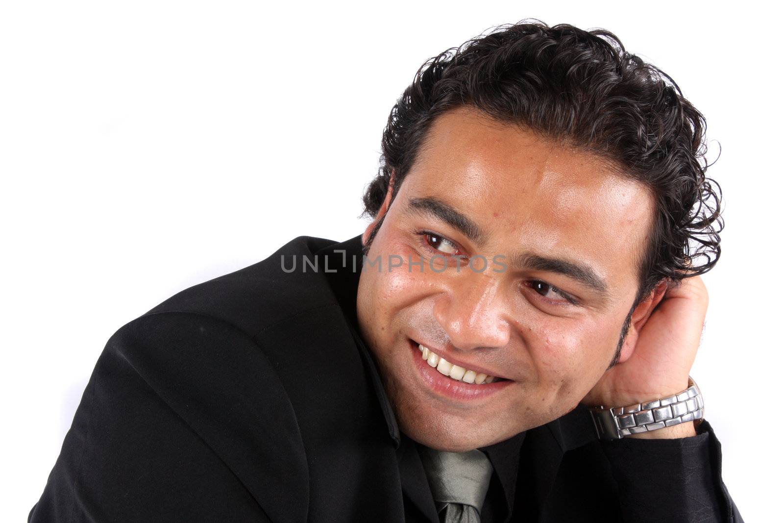 A portrait of a handsome Indian guy in a happy mood, on white studio background.
