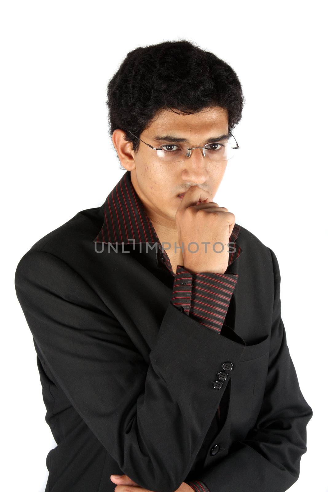 A young Indian businessman in a worried mood, on white studio background.