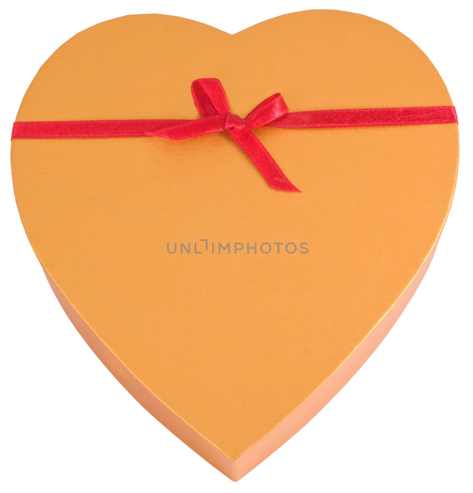 Heart shaped golden chocolate box tied with red ribbon with copyspace isolated on white