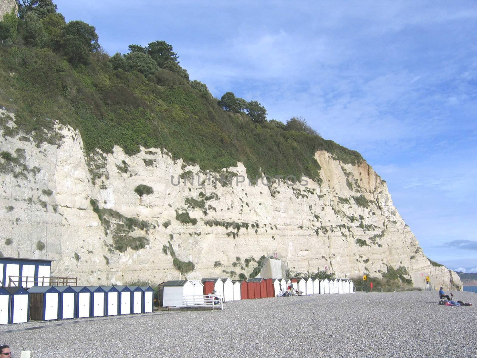 Blue Red and White Beach Huts in South Devon in England