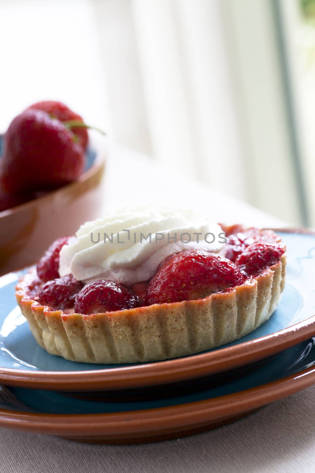 Fresh strawberry tart topped with whipped Cream