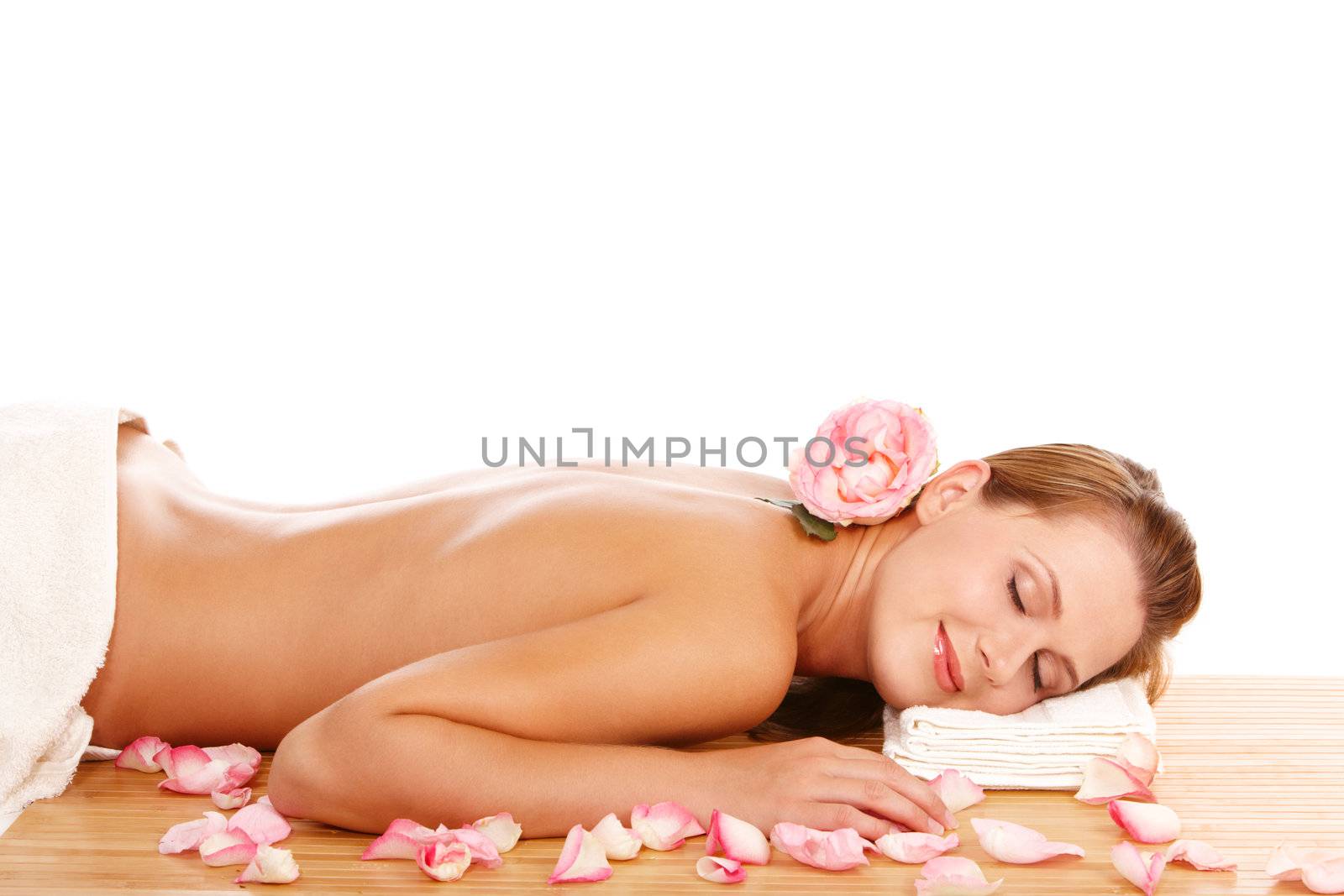 Young attractive woman lying and relaxing in spa center