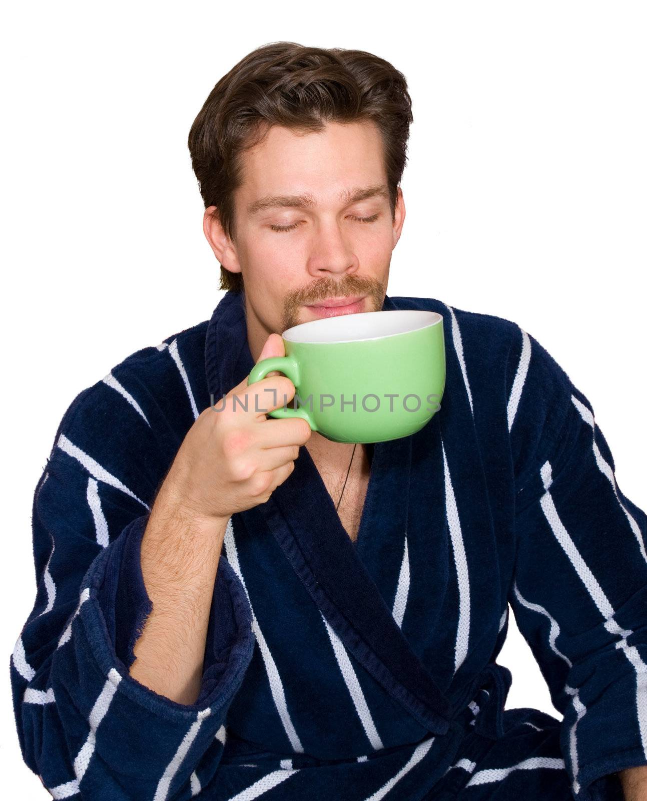 Young man in blue striped bathrobe drinks tea isolated by Keetten_Predators