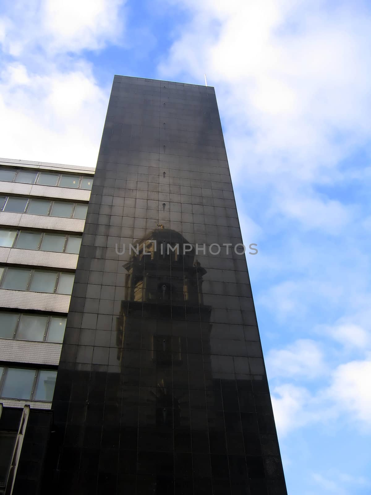 New Building in Liverpool England with Reflection of Old Historic Building in Dark Tiles