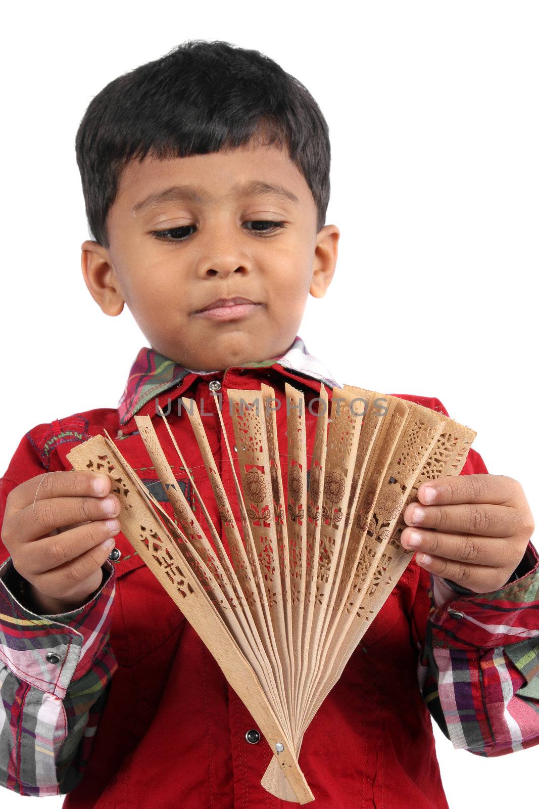 A small Indian boy with a traditional Japanese fan.