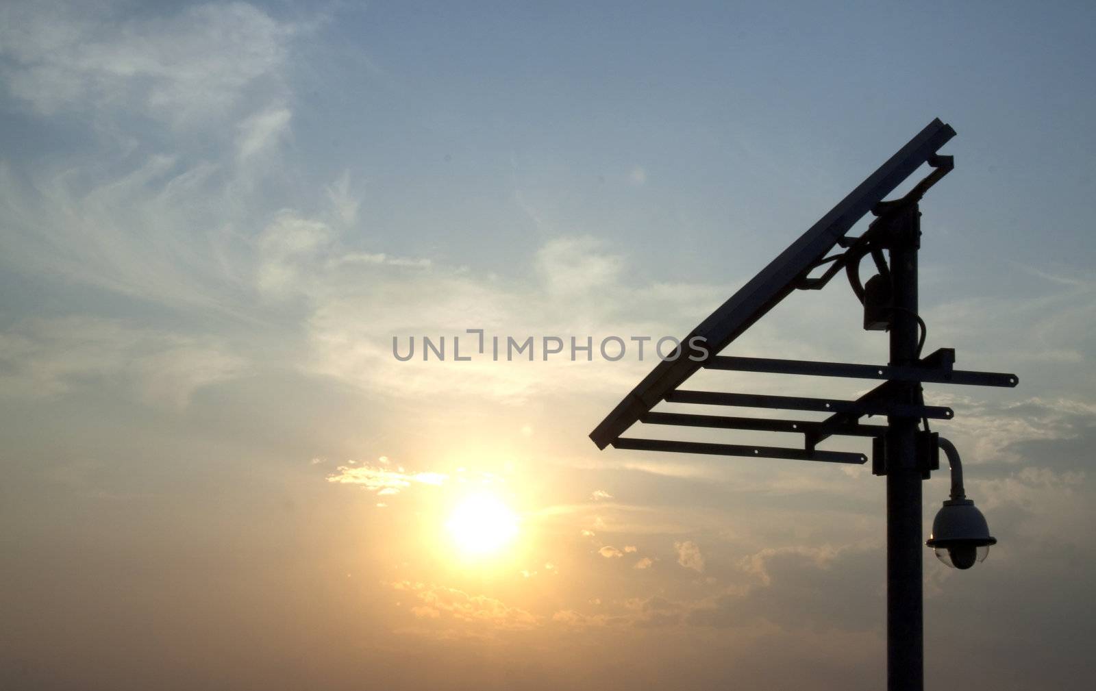 Closeup of a solar panel, blue sky, sun setting