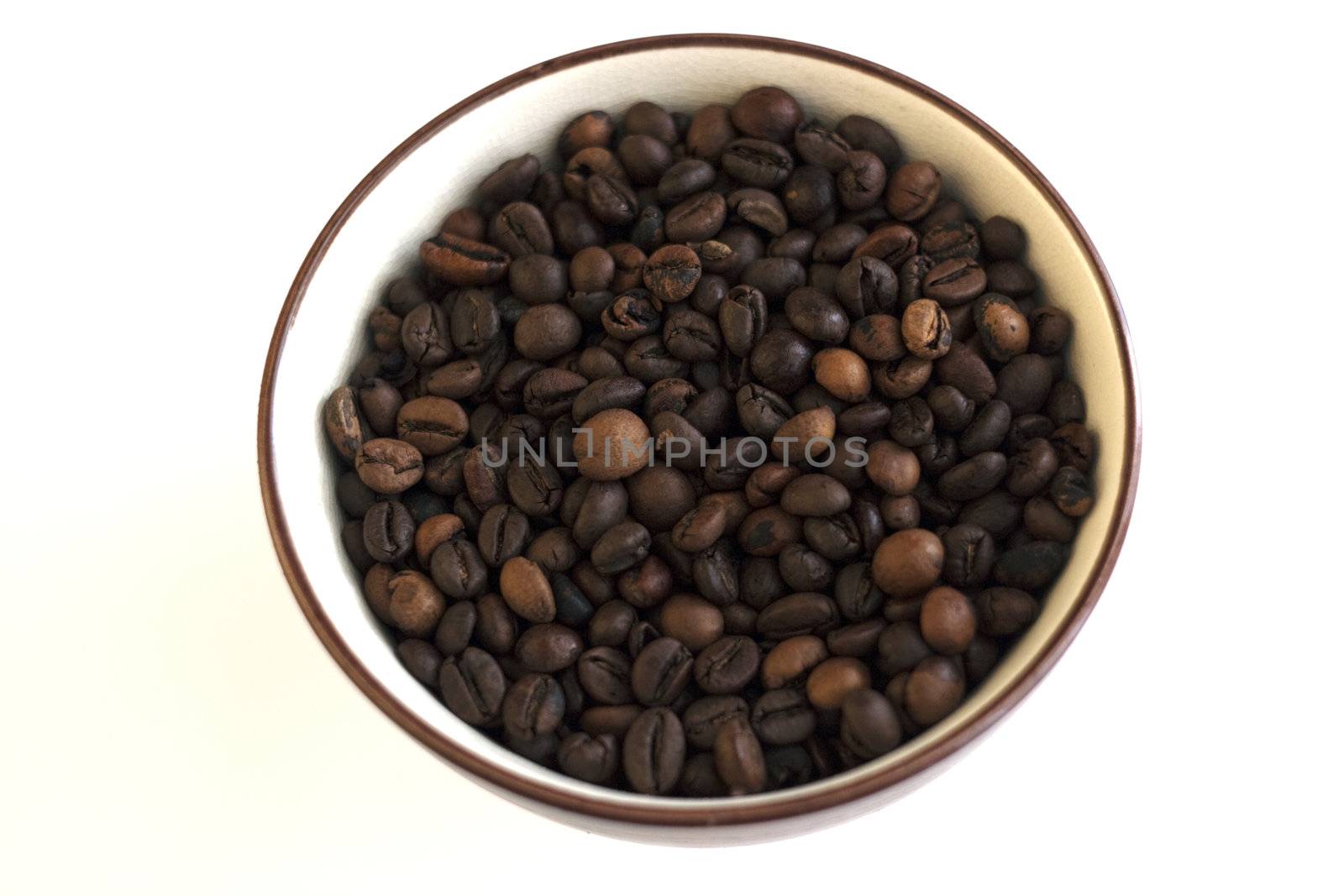 A cup full of coffee beans, white background